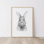 Framed bunny sketch with a bow on the floor.