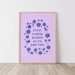 “every flower blooms in its own time” inspirational quote with floral design in blue hues - timber frame on floor