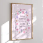 “every flower blooms in its own time” inspirational quote with floral design in pastel colours - timber frame on wall