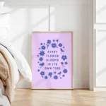 “every flower blooms in its own time” inspirational quote with floral design in blue hues - timber frame on bedroom floor