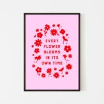 “every flower blooms in its own time” inspirational quote with floral design in red hues - black frame