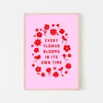 “every flower blooms in its own time” inspirational quote with floral design in red hues - timber frame