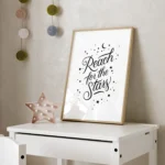 White inspirational poster: Reach for the Stars - timber frame print on desk