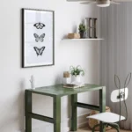 Minimalist study space with butterfly art and plants.
