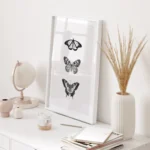 Decor with butterfly art, globe, and vase.