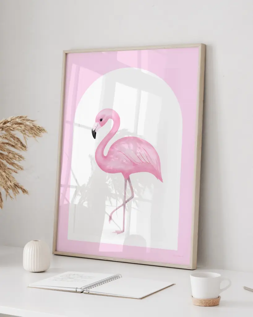 Framed pink flamingo artwork on white desk